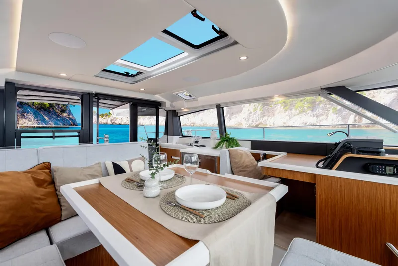 Slide: The Image of Luxurious interior of 2026 Moody 48 Deck Saloon yacht with ocean view. - 3