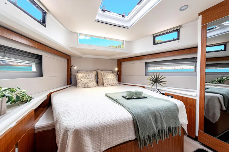 Slide: The Image of Luxurious 2026 Moody 48 Deck Saloon bedroom with skylight, modern decor, and cozy bedding. - 4