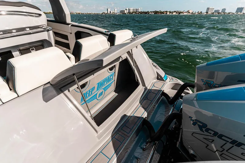 Slide: The Image of 2027 Deep Impact 399 Fwd Cabin boat on water, showcasing sleek design and powerful engines. - 19