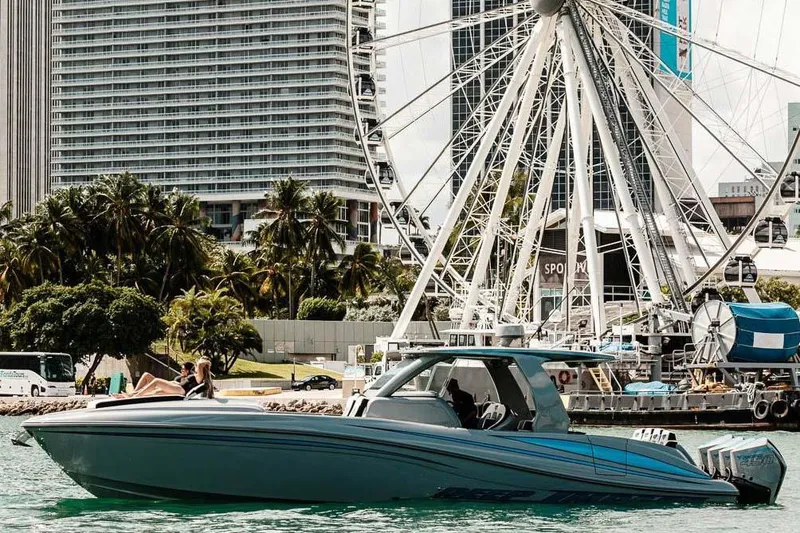 Slide: The Image of 2027 Deep Impact 399 Fwd Cabin boat cruising near a Ferris wheel and cityscape. - 3