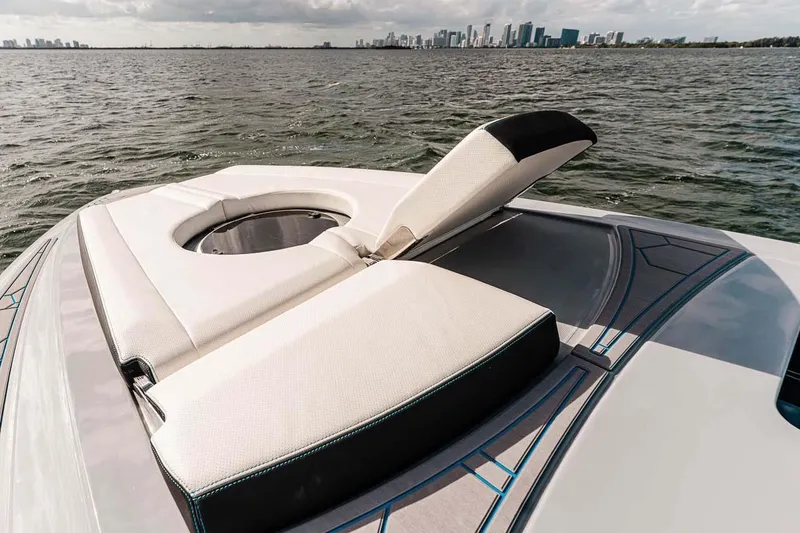 Slide: The Image of Luxury 2027 Deep Impact 399 Fwd Cabin boat with sunbed, city skyline in background. - 4