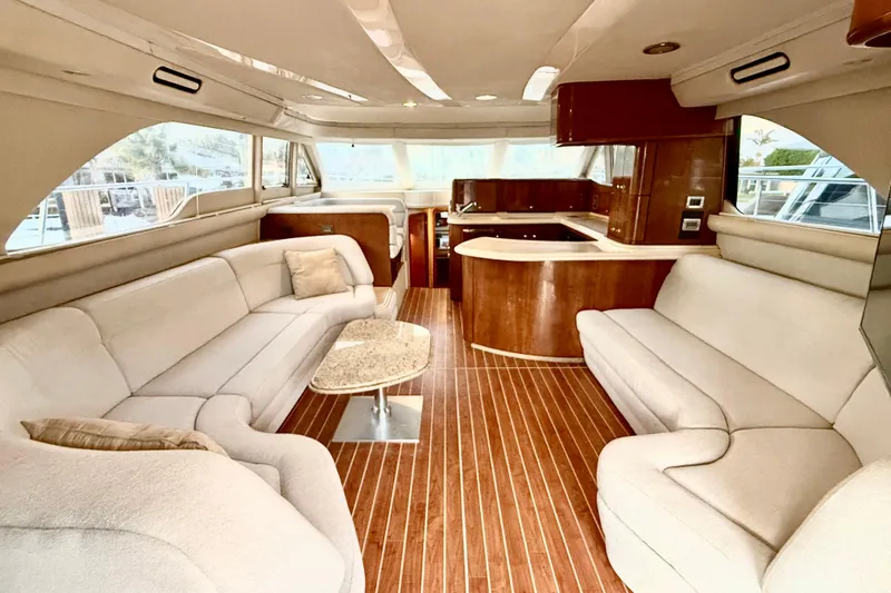 Slide: The Image of Luxurious interior of 1999 Sea Ray 560 Sedan Bridge yacht with elegant seating and wood finishes. - 13