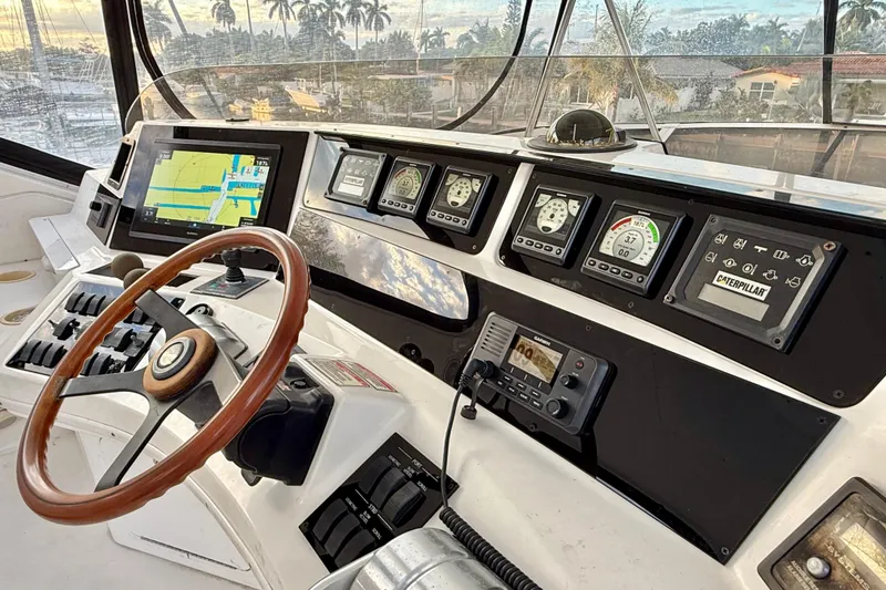 Slide: The Image of 1999 Sea Ray 560 Sedan Bridge helm with navigation and control instruments. - 8