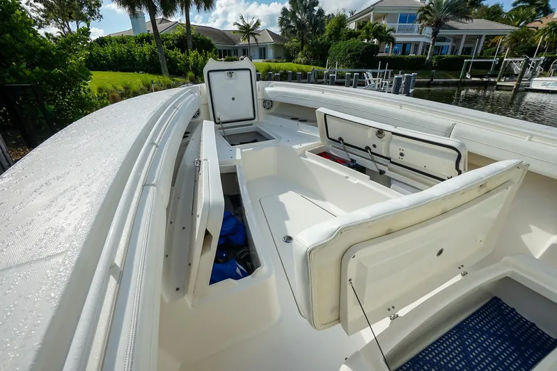 Slide: The Image of 2021 Regulator 31 boat interior with open storage compartments, docked near waterfront homes. - 14
