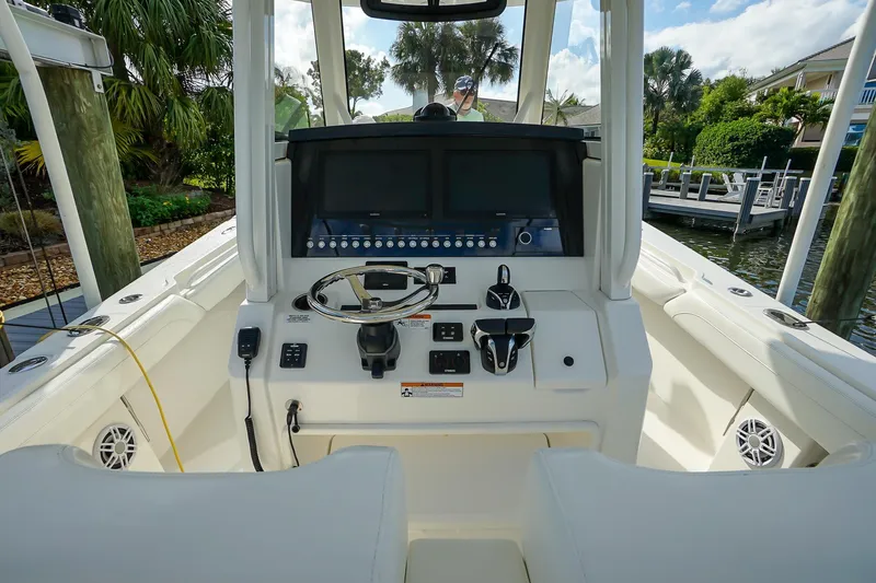 Slide: The Image of 2021 Regulator 31 boat cockpit with steering wheel and control panel. - 15