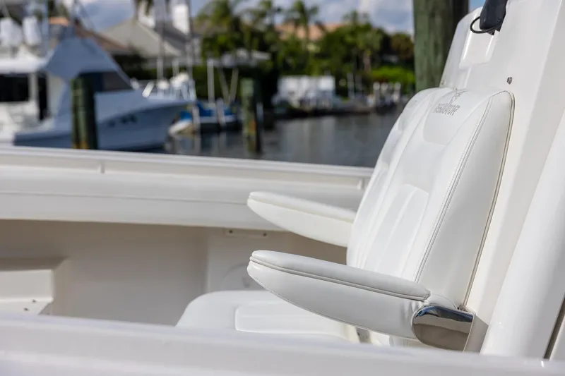 Slide: The Image of 2021 Regulator 31 boat with white seating, docked at a marina. - 24