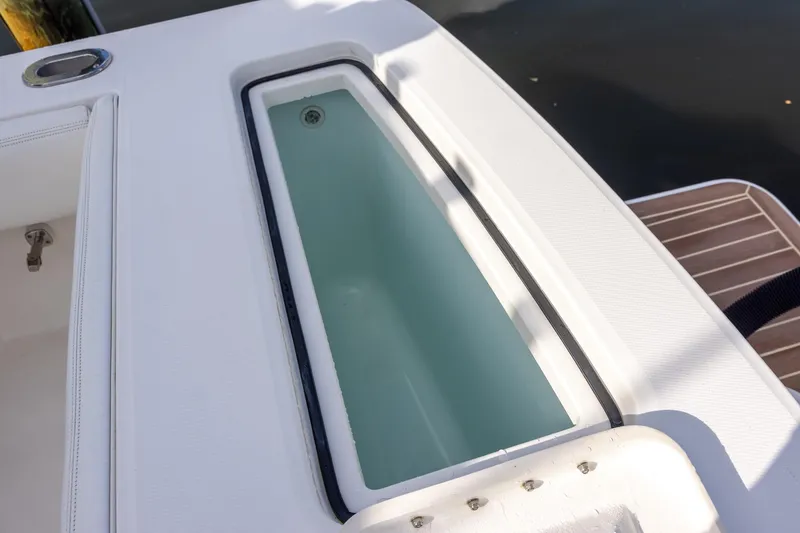 Slide: The Image of Livewell on 2021 Regulator 31 boat, featuring sleek white design and spacious interior. - 26