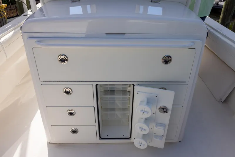 Slide: The Image of 2021 Regulator 31 boat storage compartment with open door and drawers. - 32