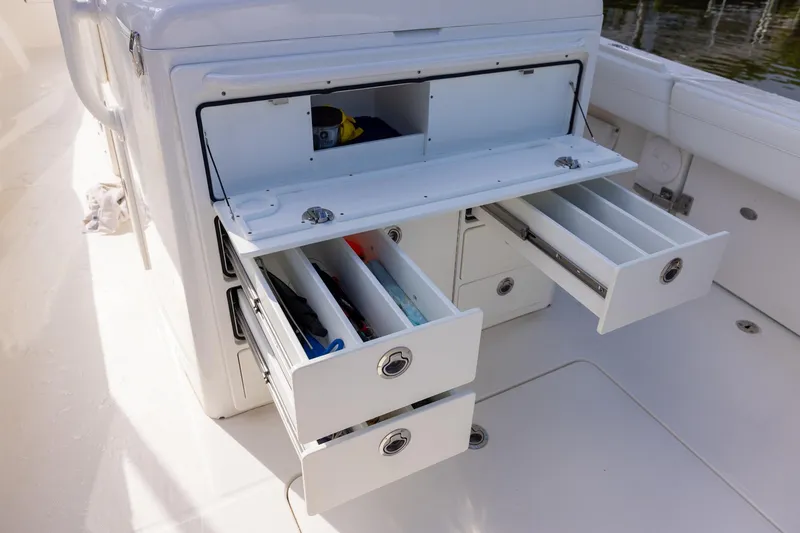 Slide: The Image of 2021 Regulator 31 boat storage compartments with open drawers and organized interior. - 33