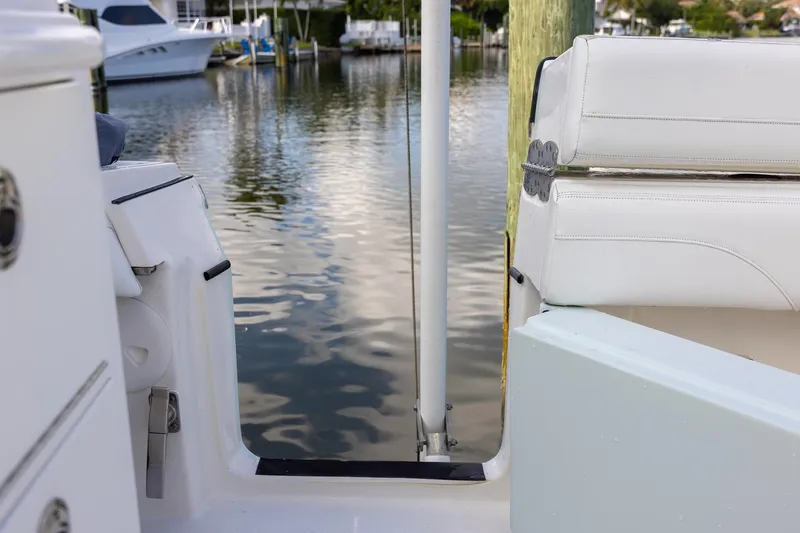 Slide: The Image of 2021 Regulator 31 boat interior with white seating, docked by calm water. - 34