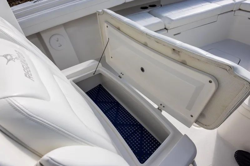 Slide: The Image of 2021 Regulator 31 boat interior with open storage compartment and cushioned seating. - 36
