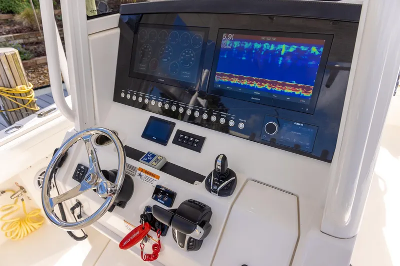 Slide: The Image of 2021 Regulator 31 boat dashboard with steering wheel and navigation display. - 40