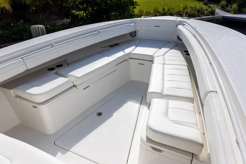 Slide: The Image of Luxurious seating area on a 2021 Regulator 31 boat, featuring white cushioned benches. - 41