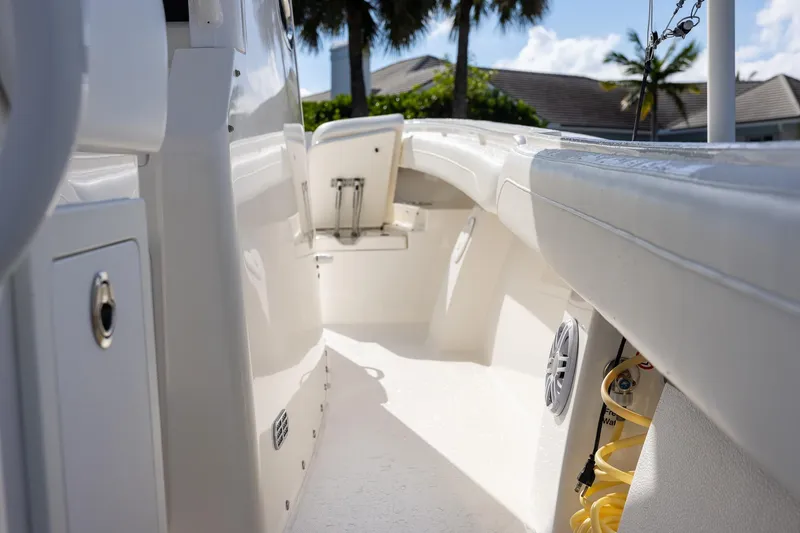 Slide: The Image of 2021 Regulator 31 boat interior with white seating and storage compartments. - 45
