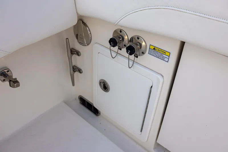Slide: The Image of 2021 Regulator 31 boat interior with utility panel and caution label. - 50