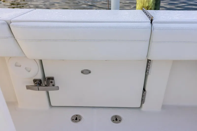 Slide: The Image of 2021 Regulator 31 boat with white cushioned seating and storage compartment. - 51