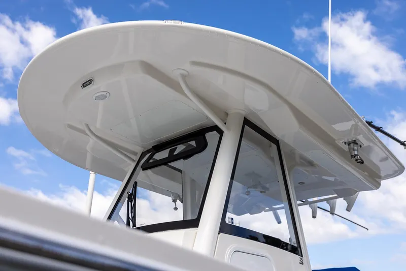 Slide: The Image of 2021 Regulator 31 boat with sleek design against a blue sky background. - 52