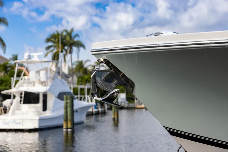 Slide: The Image of Bow of 2021 Regulator 31 boat with anchor, docked near palm trees. - 53