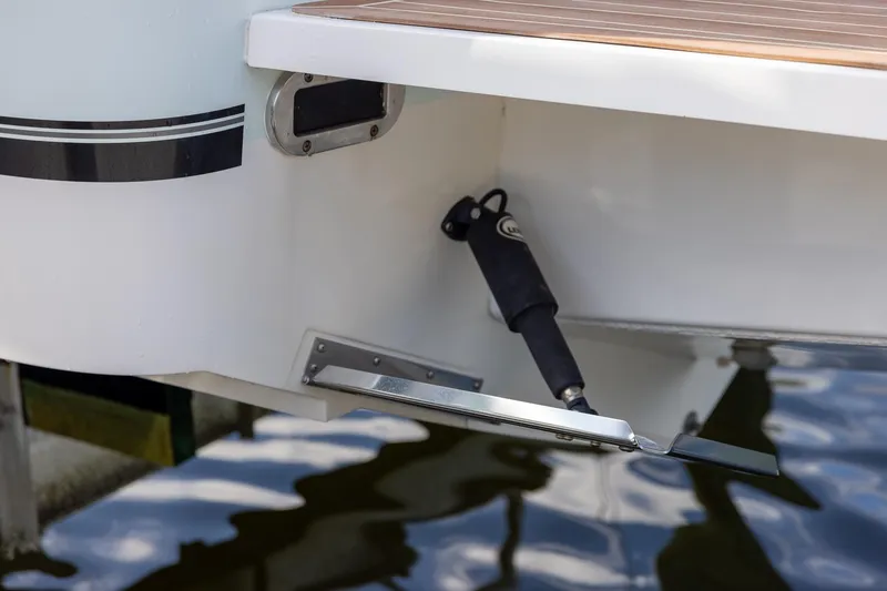 Slide: The Image of 2021 Regulator 31 boat trim tab detail with water reflection. - 56