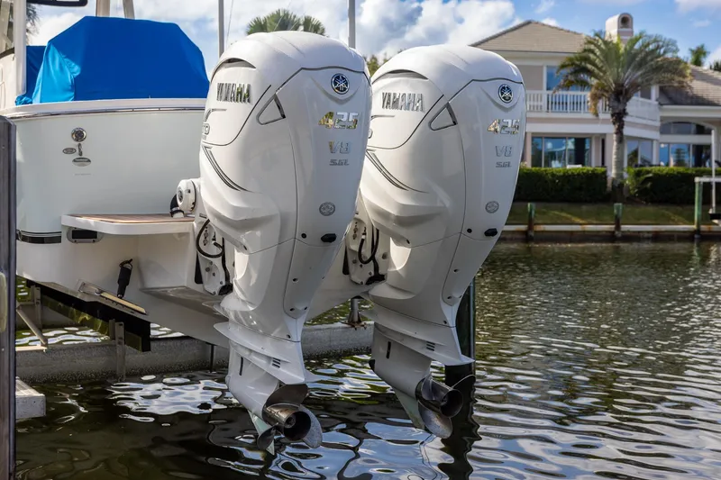 Slide: The Image of 2021 Regulator 31 boat with twin Yamaha 425 V8 outboard engines docked by waterfront homes. - 57