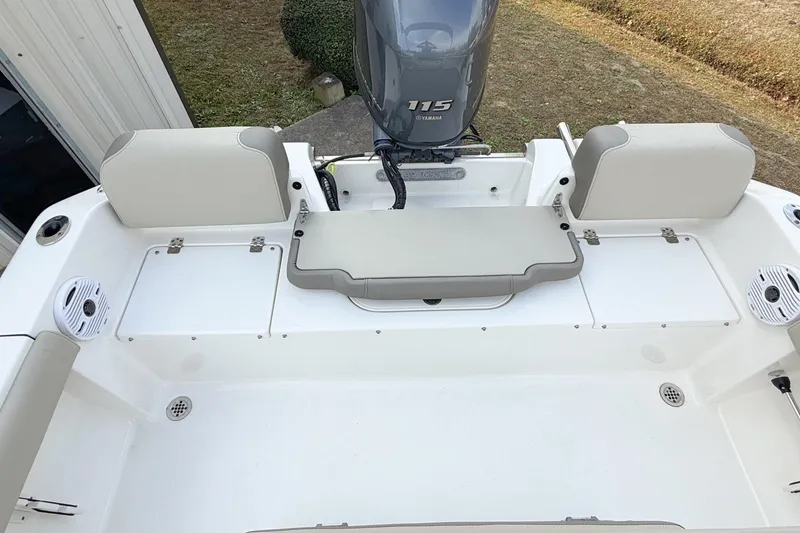 Slide: The Image of 2021 Key West 189 FS boat interior with Yamaha 115 engine, featuring seating and storage. - 10