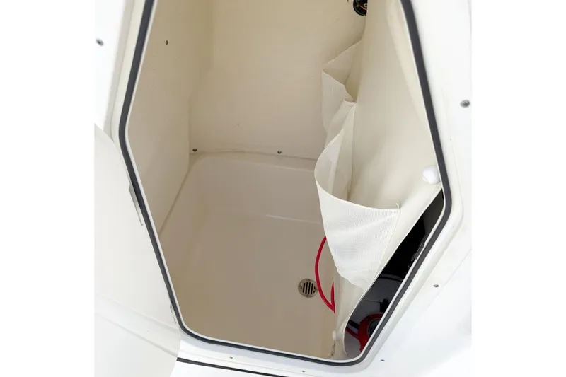 Slide: The Image of 2021 Key West 189 FS boat storage compartment with drain and netting. - 11