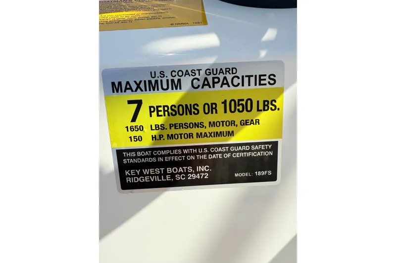 Slide: The Image of 2021 Key West 189 FS boat capacity label, 7 persons or 1050 lbs, U.S. Coast Guard compliant. - 18