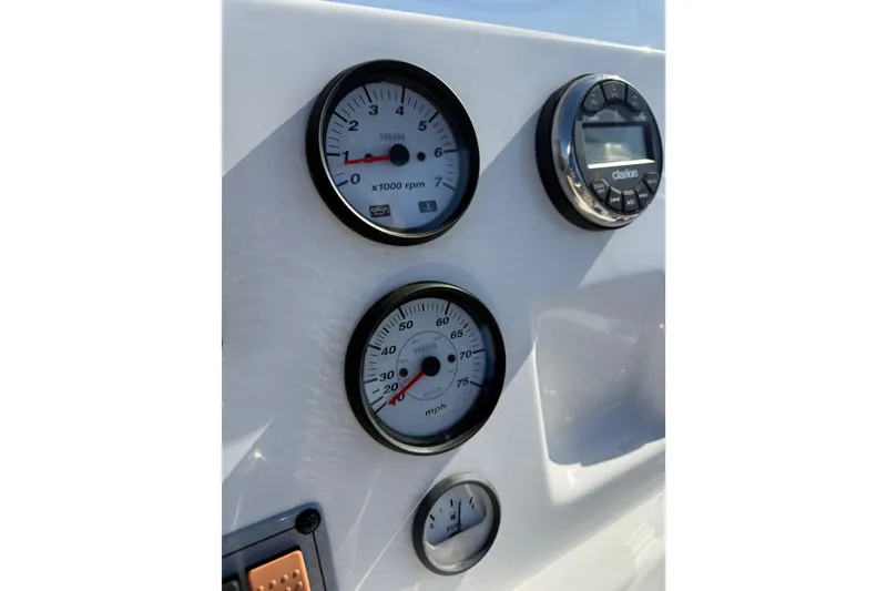 Slide: The Image of Dashboard of 2021 Key West 189 FS boat with gauges and Clarion audio system. - 21