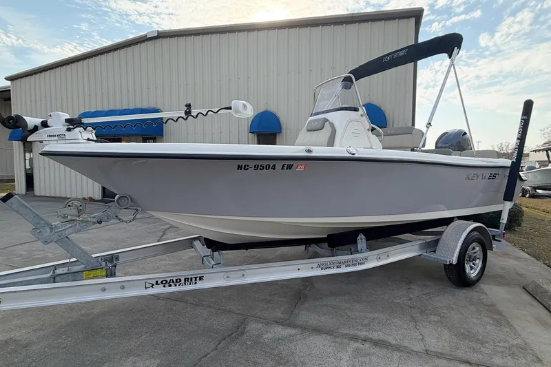 Slide: The Image of 2021 Key West 189 FS boat on trailer, parked outside a building. - 3