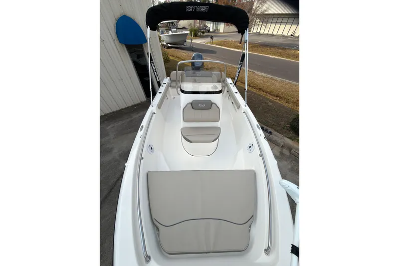 Slide: The Image of 2021 Key West 189 FS boat with seating and canopy, parked outdoors. - 7