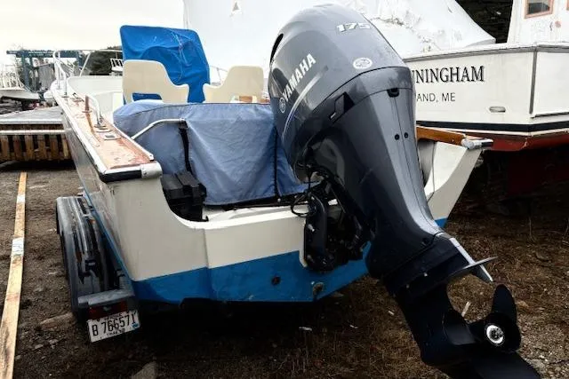 Slide: The Image of 1984 Boston Whaler Outrage 22 with Yamaha 175 outboard motor, parked on a trailer. - 2