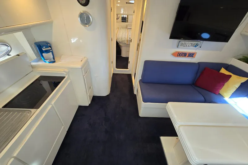 Slide: The Image of Interior of 1993 Giorgi 46 yacht with modern kitchen and cozy seating area. - 100