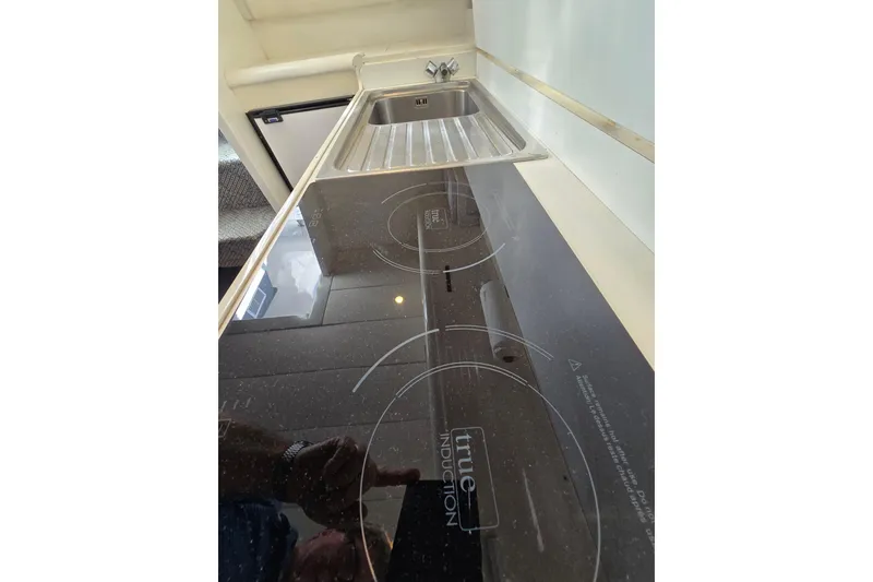 Slide: The Image of Modern kitchen with induction cooktop and stainless steel sink in a 1993 Giorgi 46 model. - 102