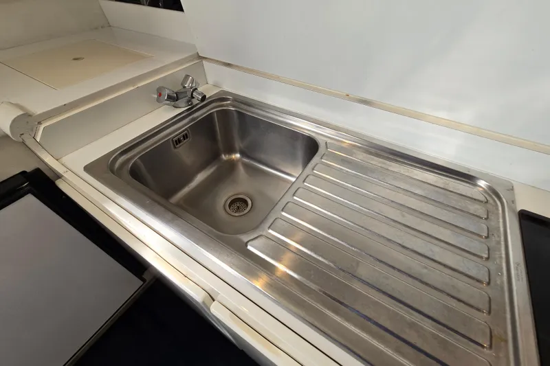 Slide: The Image of Stainless steel sink and drainer in a 1993 Giorgi 46 model kitchen area. - 104