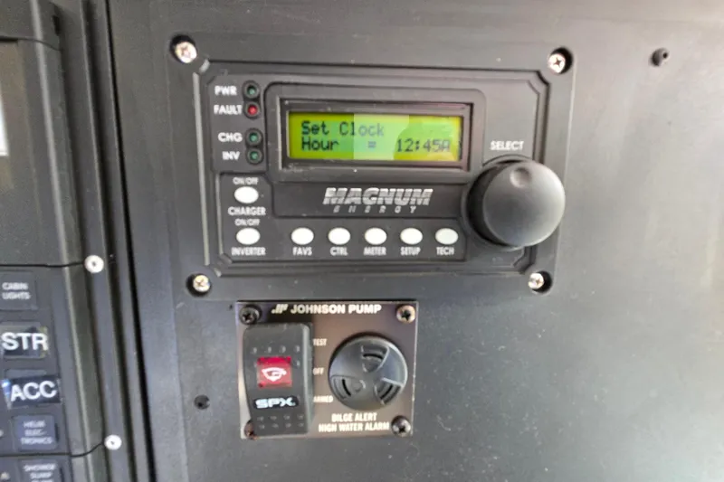 Slide: The Image of Control panel with Magnum Energy display and Johnson Pump bilge alarm, Giorgi 46, 1993 model. - 111