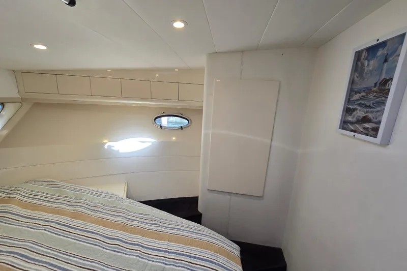 Slide: The Image of Interior of 1993 Giorgi 46 yacht cabin with striped bedding and nautical decor. - 123