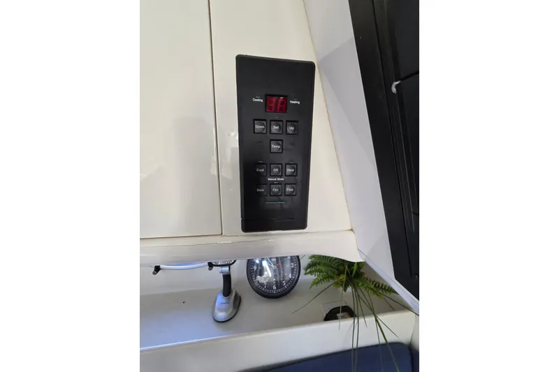 Slide: The Image of Control panel inside a 1993 Giorgi 46 boat, featuring temperature and fan settings. - 130