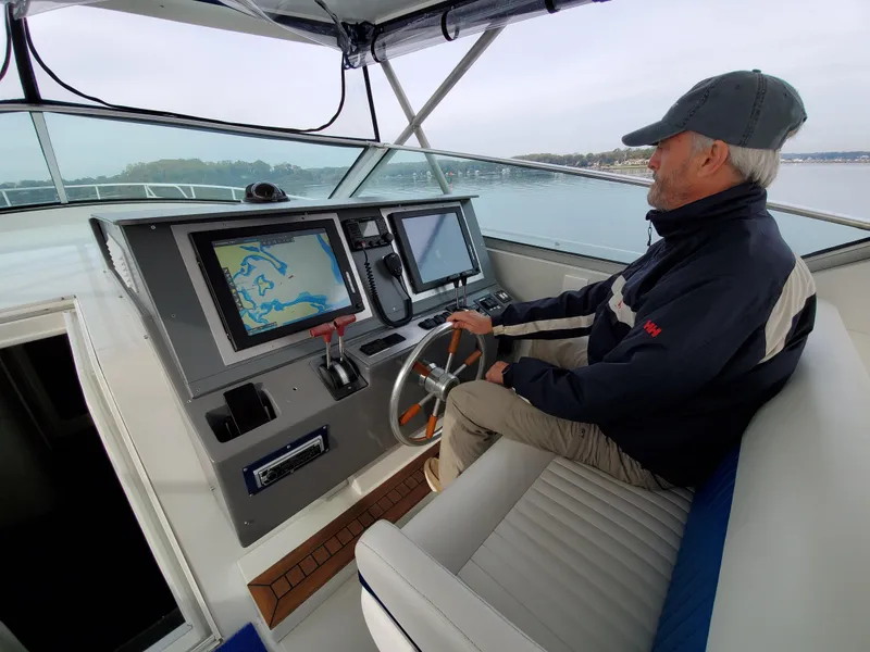 Slide: The Image of Man steering Giorgi 46 boat, 1993 model, with navigation screens, on a calm waterway. - 4