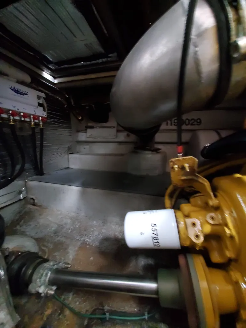 Slide: The Image of Engine room of a 1993 Giorgi 46 boat, showcasing mechanical components and wiring. - 42