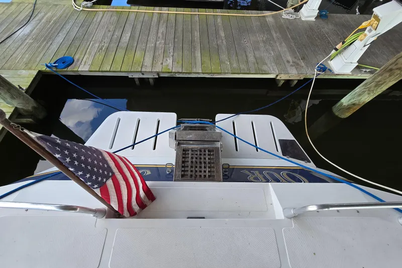 Slide: The Image of American flag on 1993 Giorgi 46 yacht docked at marina. - 87