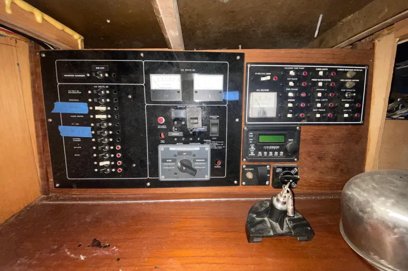 Slide: The Image of Electrical control panel of a 1966 Vanguard Bermudian Sloop, featuring various switches and meters. - 11