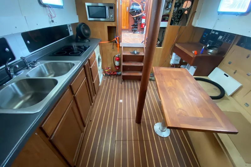Slide: The Image of Interior of 1966 Vanguard Bermudian Sloop with kitchen and dining area. - 13