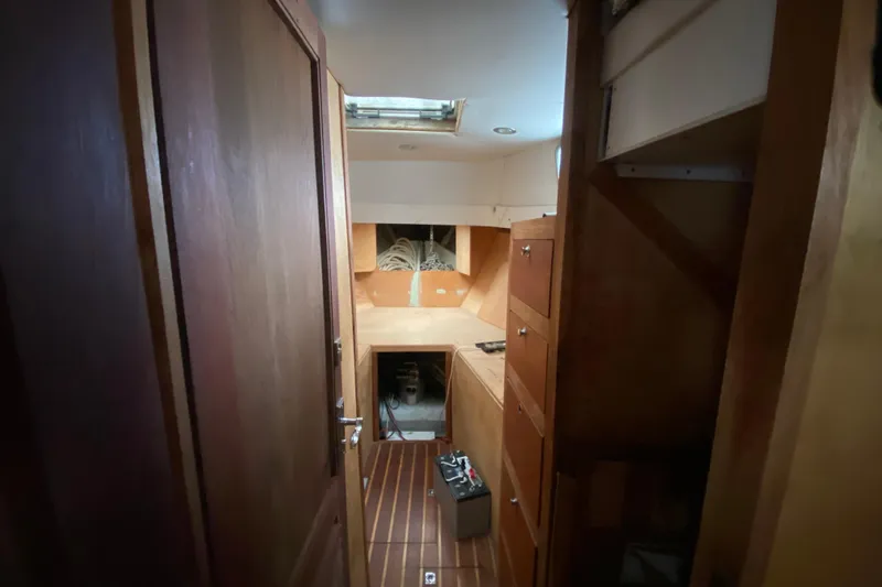 Slide: The Image of Interior of a 1966 Vanguard Bermudian Sloop with wooden cabinetry and flooring. - 14
