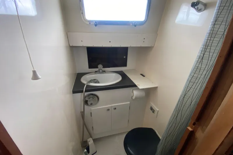 Slide: The Image of Compact bathroom in 1966 Vanguard Bermudian Sloop with sink, window, and toilet. - 16