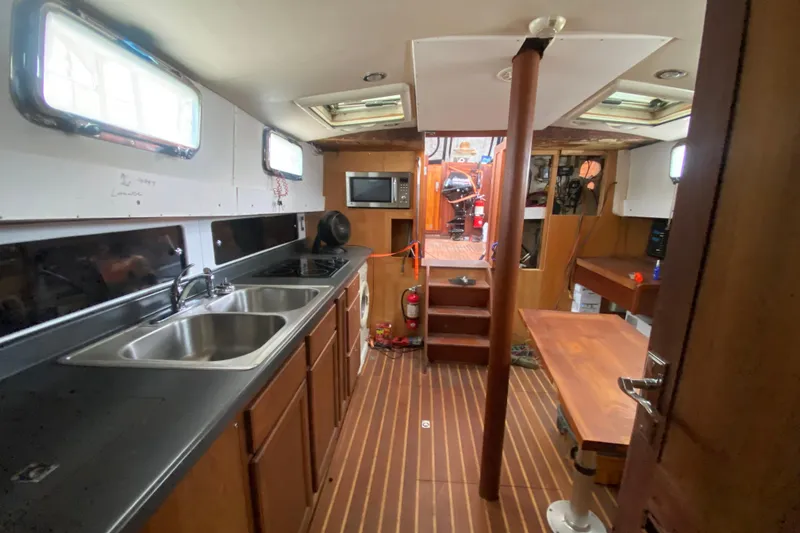 Slide: The Image of Interior of a 1966 Vanguard Bermudian Sloop with kitchen and dining area. - 18