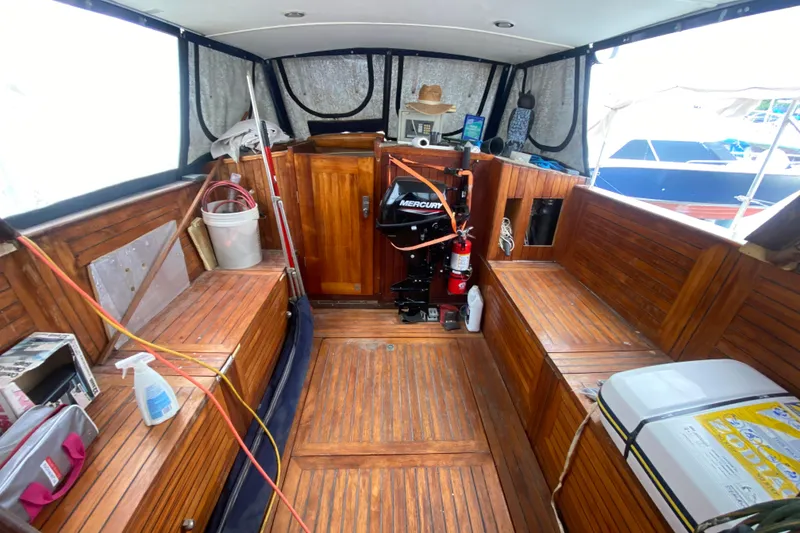 Slide: The Image of Interior of a 1966 Vanguard Bermudian Sloop with wooden seating and Mercury engine. - 19
