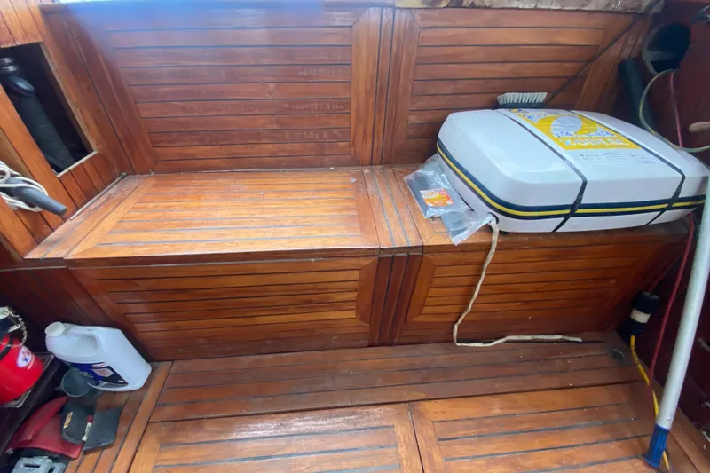 Slide: The Image of Interior of 1966 Vanguard Bermudian Sloop with wooden seating and safety equipment. - 22