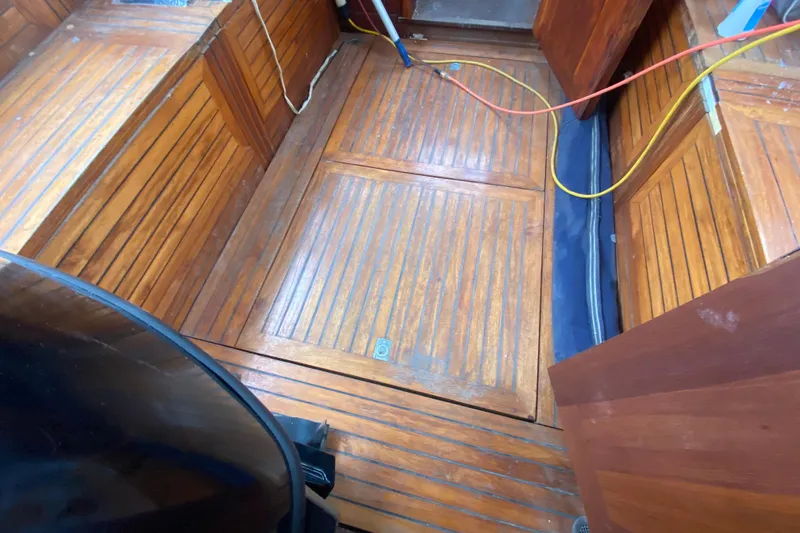 Slide: The Image of Interior of 1966 Vanguard Bermudian Sloop with wooden flooring and storage compartments. - 23