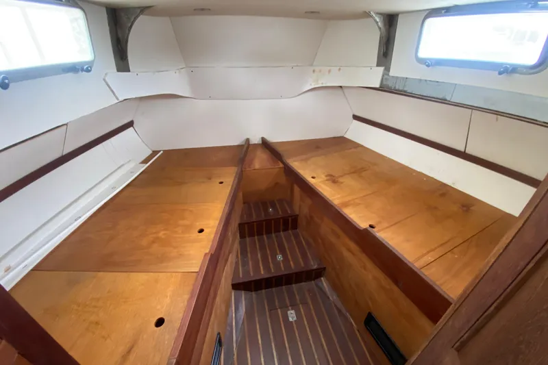 Slide: The Image of Interior of 1966 Vanguard Bermudian Sloop with wooden flooring and white walls. - 25