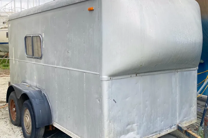 Slide: The Image of Silver trailer beside a Vanguard Bermudian Sloop, 1966 model, in a boatyard setting. - 28